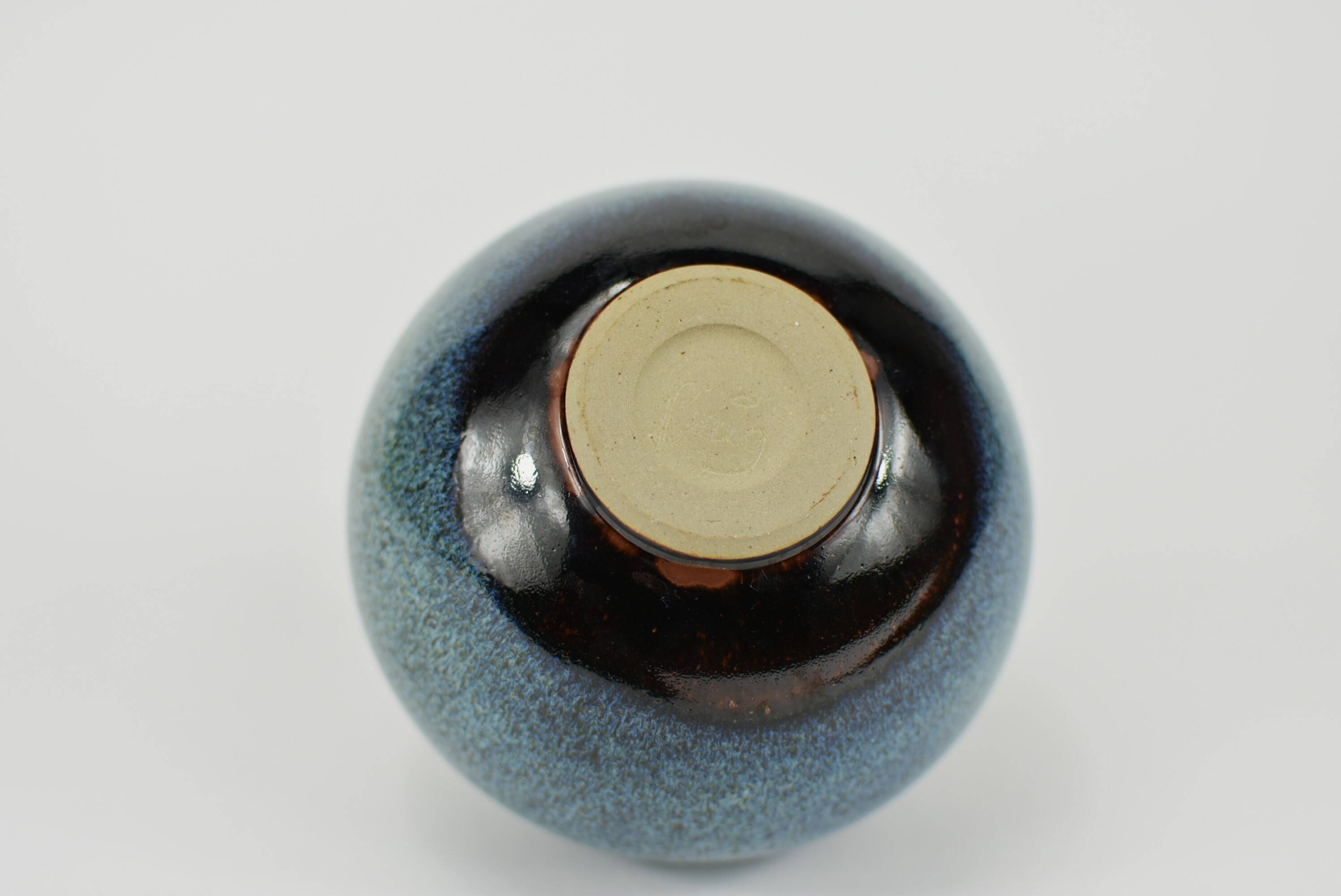 Vase with blue flowers.