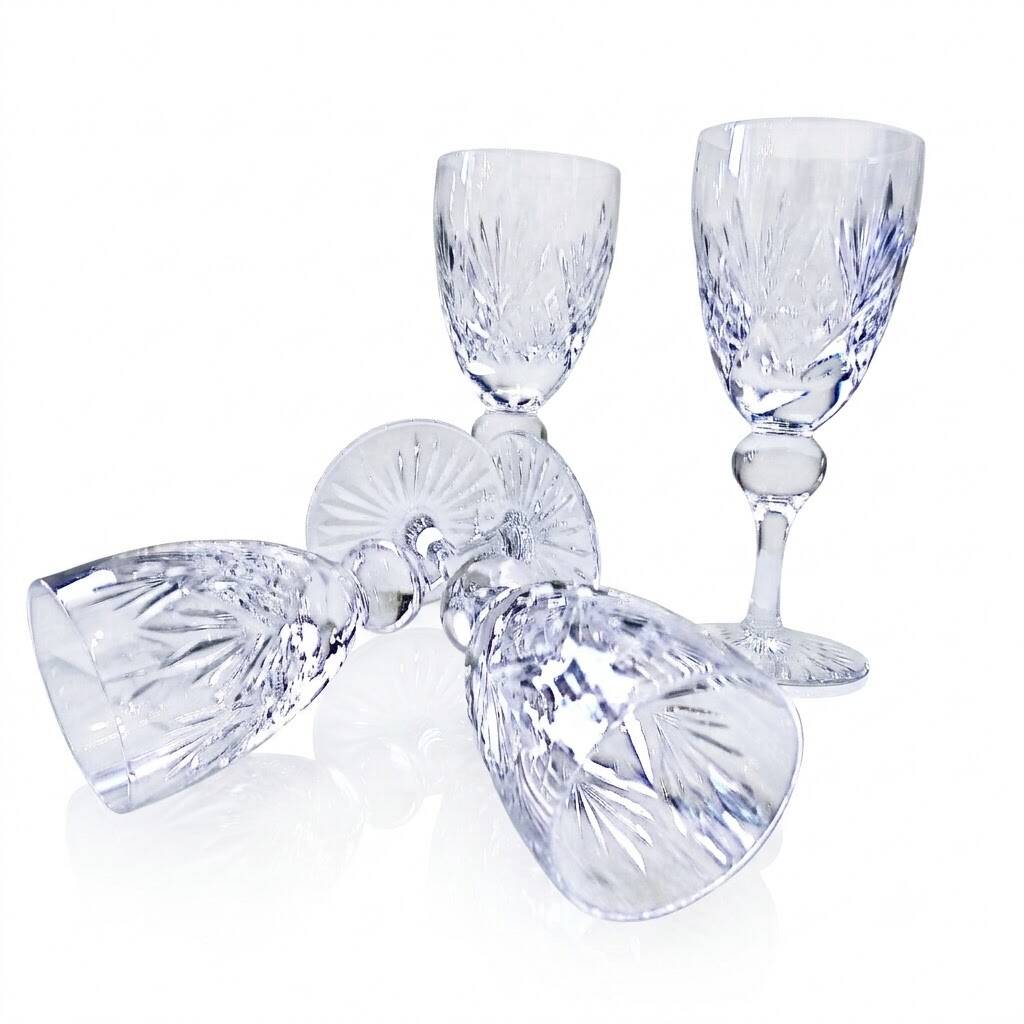 Cut crystal white wine glasses with a slender baluster-shaped stem.