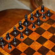 High Victorian leather tête-à-tête canapé with a walnut burr chessboard.