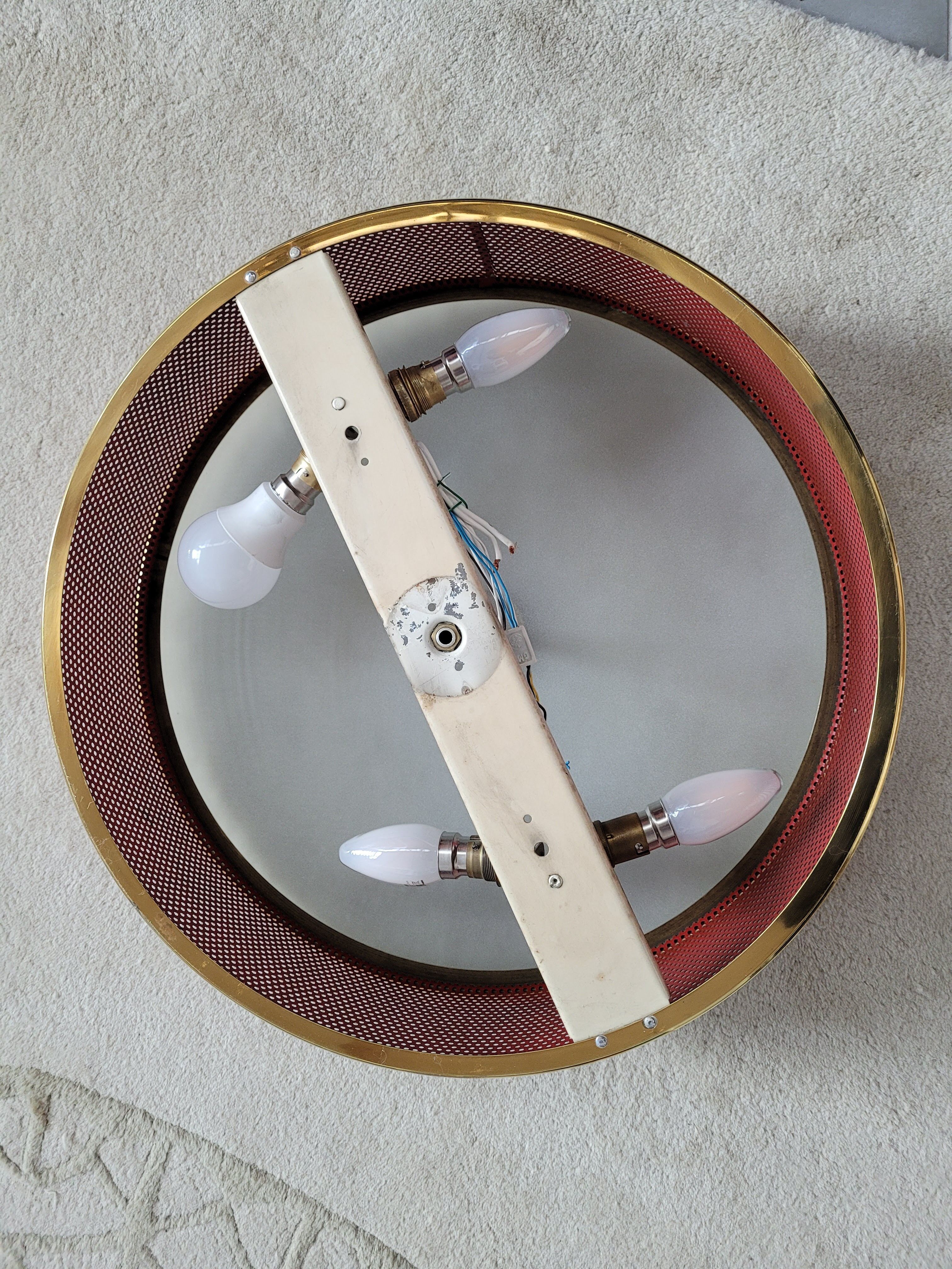 Ceiling lamp applied in red lacquered perforated metal