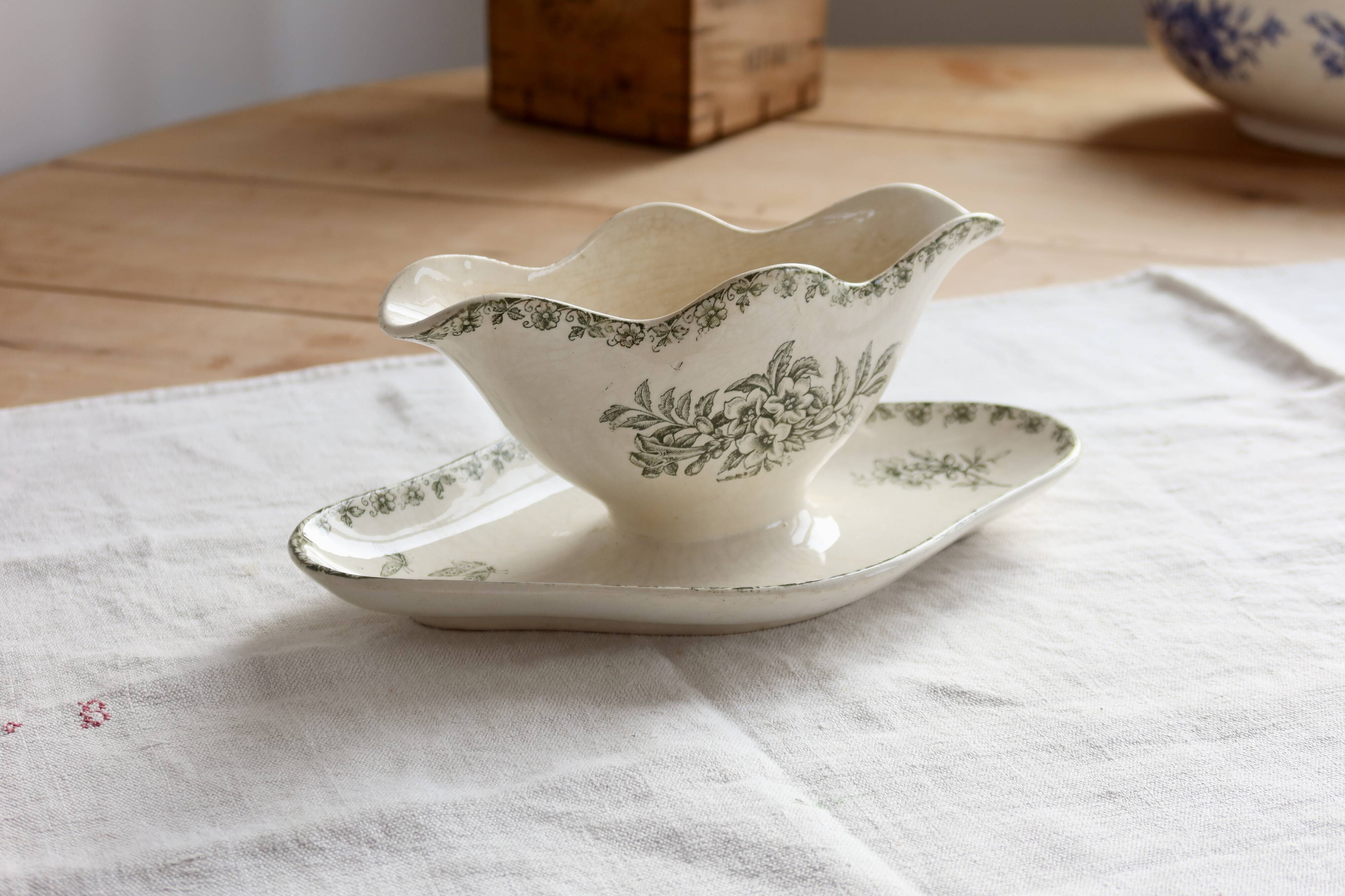 Antique sauce boat, ironstone, ivory with green floral and butterfly decoration.