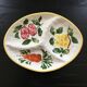 Serving platter decorated with fruits and vegetables.
