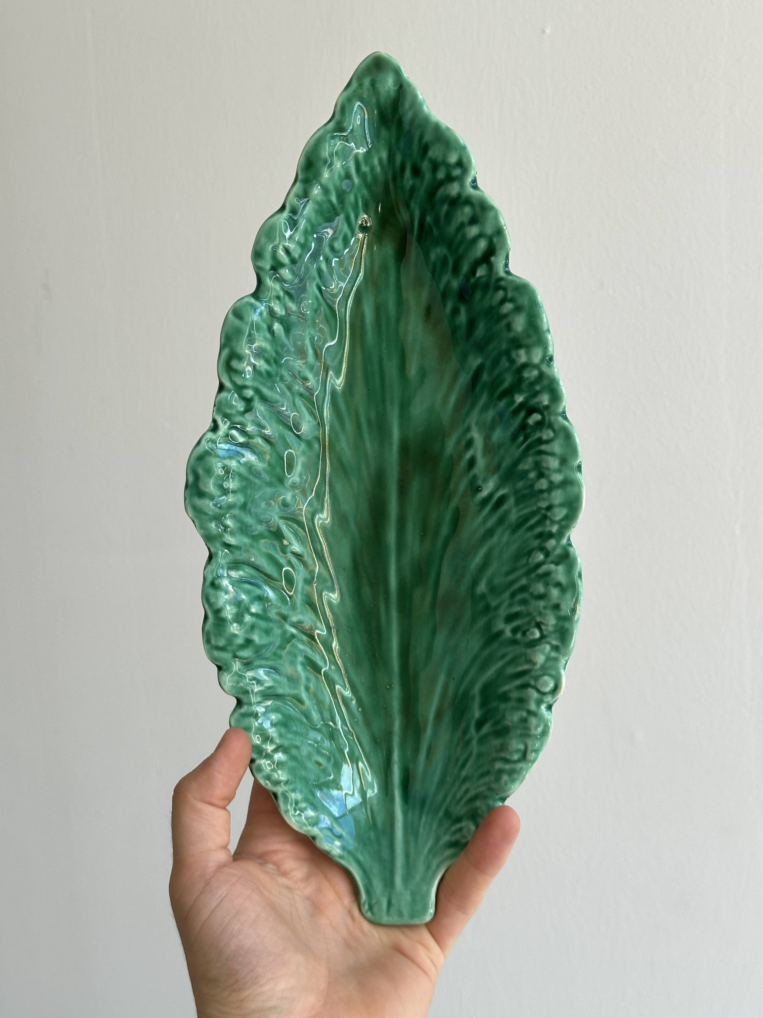 Green earthenware dish in the shape of a leaf