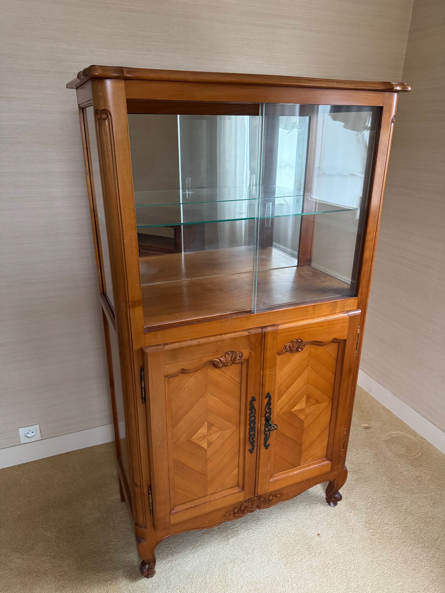 Louis XV style display cabinet, glass doors and chevron panels.