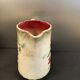 Antique pitcher in slipware with floral decoration – red and cream floral design