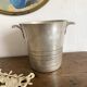 Antique champagne bucket with shell handles.