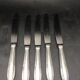 9 table knives in silver metal.