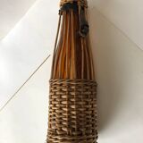 Amber and wicker glass bottle