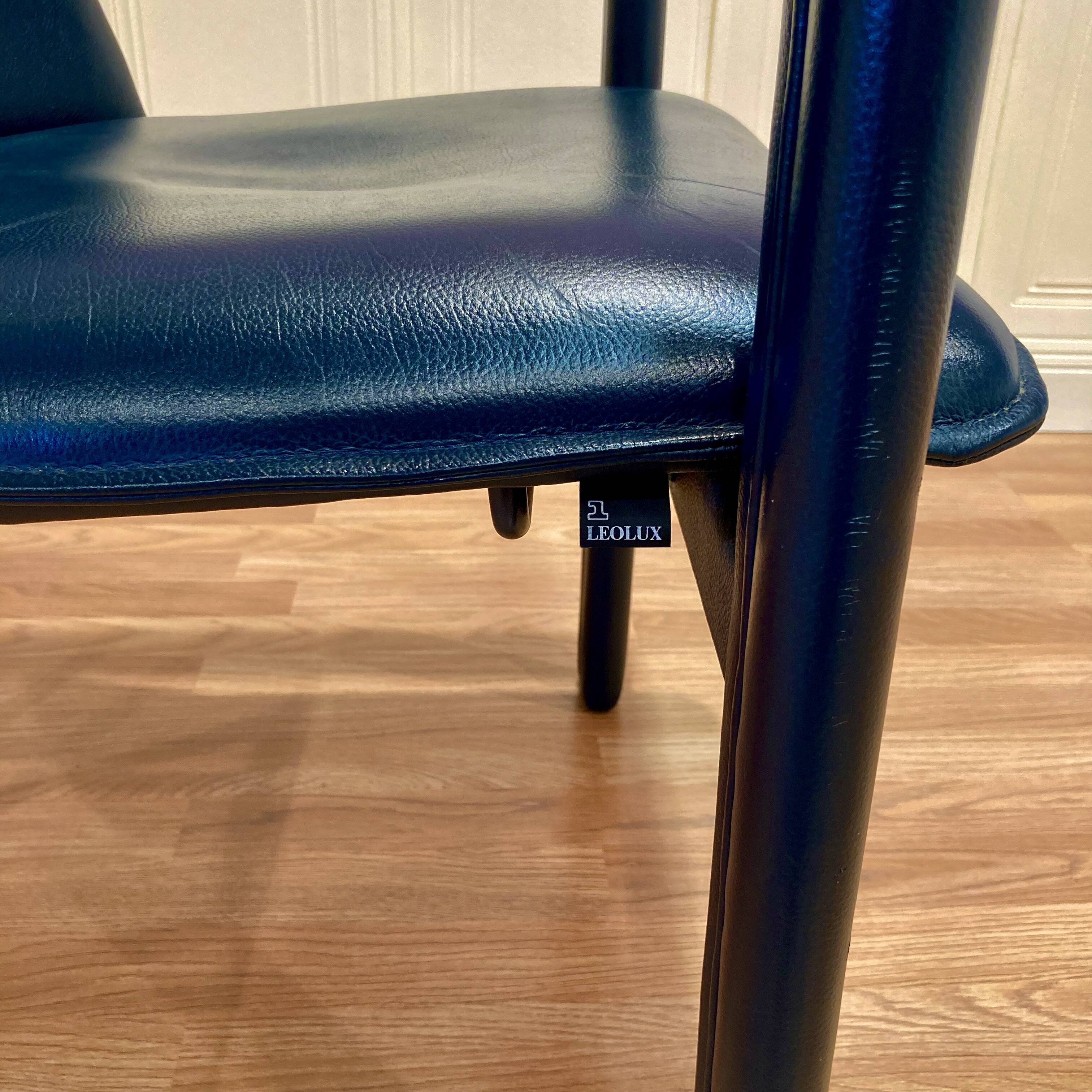 Set of 3 designer leather and metal armchairs.