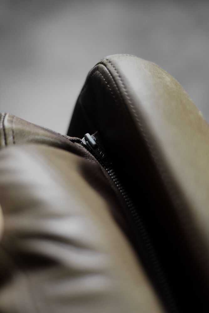 High teak and brown leather armchair with reclining backrest, mid-century Danish style, 1960s.