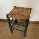Vintage stool in green patinated wood and straw