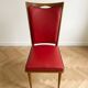 Set of 6 vintage wooden chairs with red faux leather in retro style.