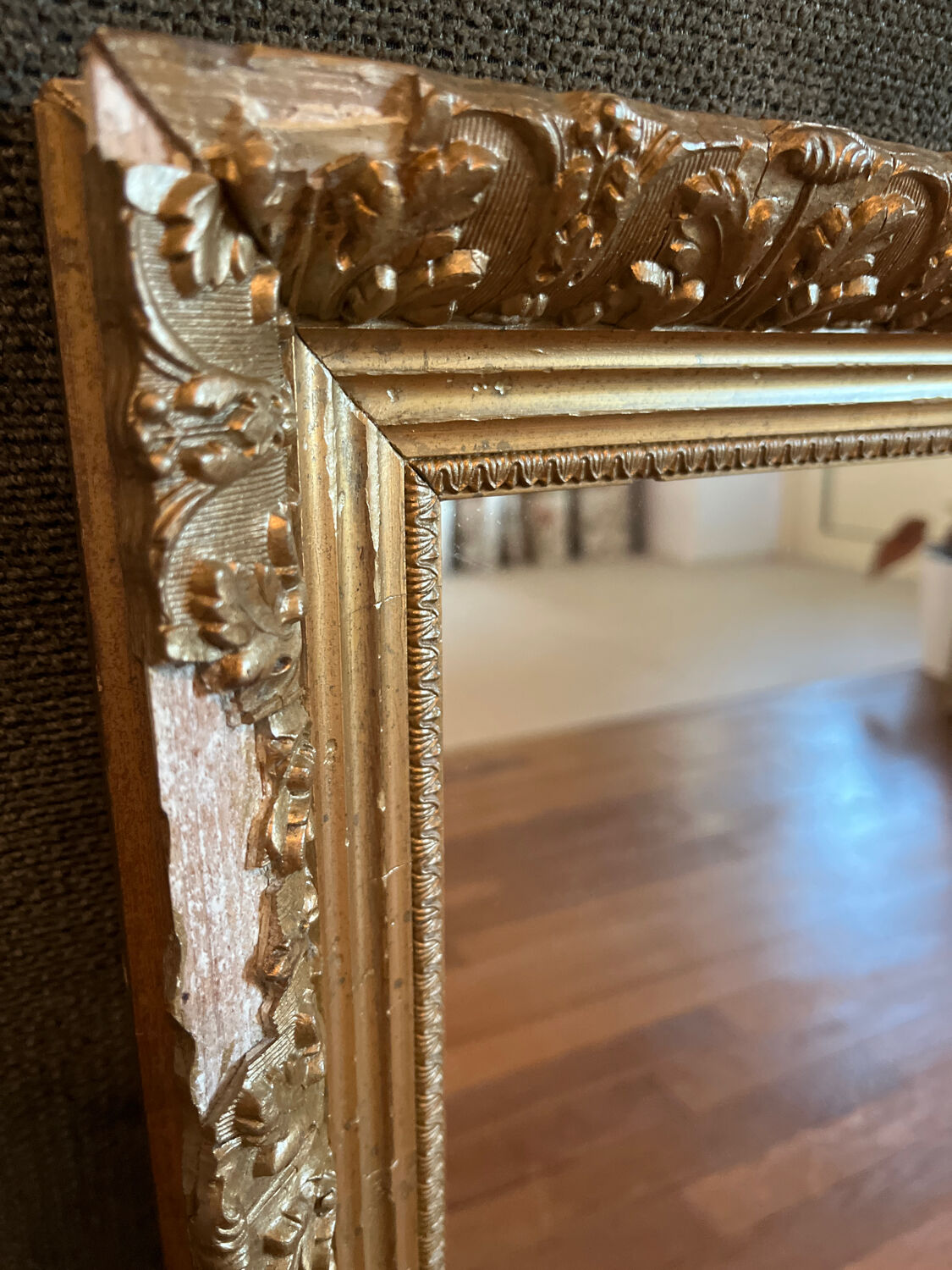 Antique mirror with a wooden and gilded stucco frame.