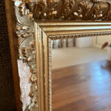 Antique mirror with a wooden and gilded stucco frame.