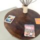 Brutalist coffee table in solid teak, monolithic slab, tripod base.