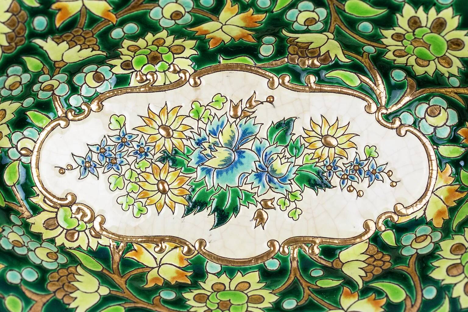 Longwy cup in cloisonné enamels on a green background, polychrome floral decoration and gold