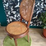 Wooden chair sitting in cannage