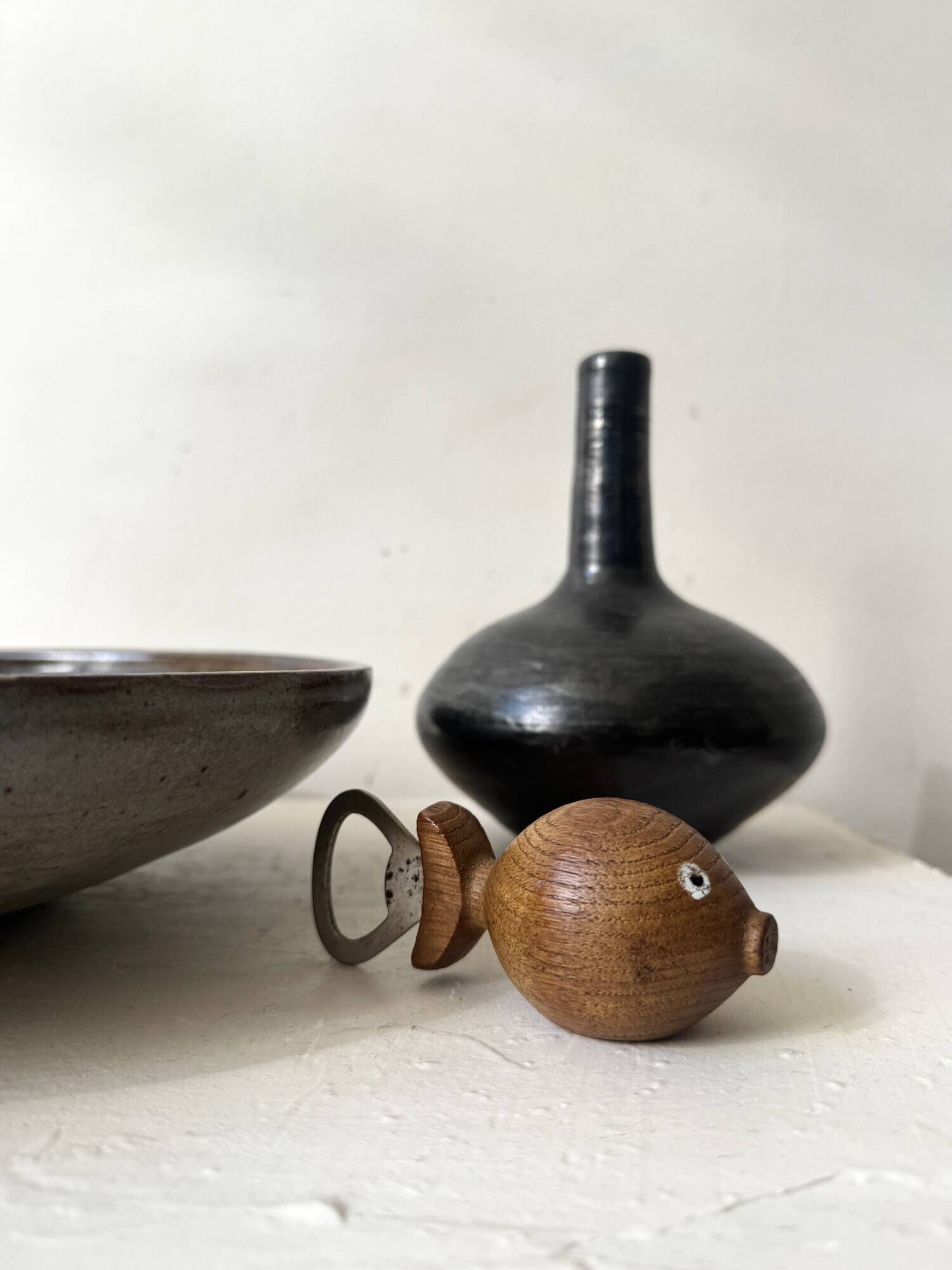 Glazed black ceramic vase with a single stem, signed, circa 1950.