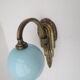 Applique art déco en laiton  et globe opaline bleu doux
