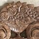 Wall-mounted coat rack on a carved wooden pediment