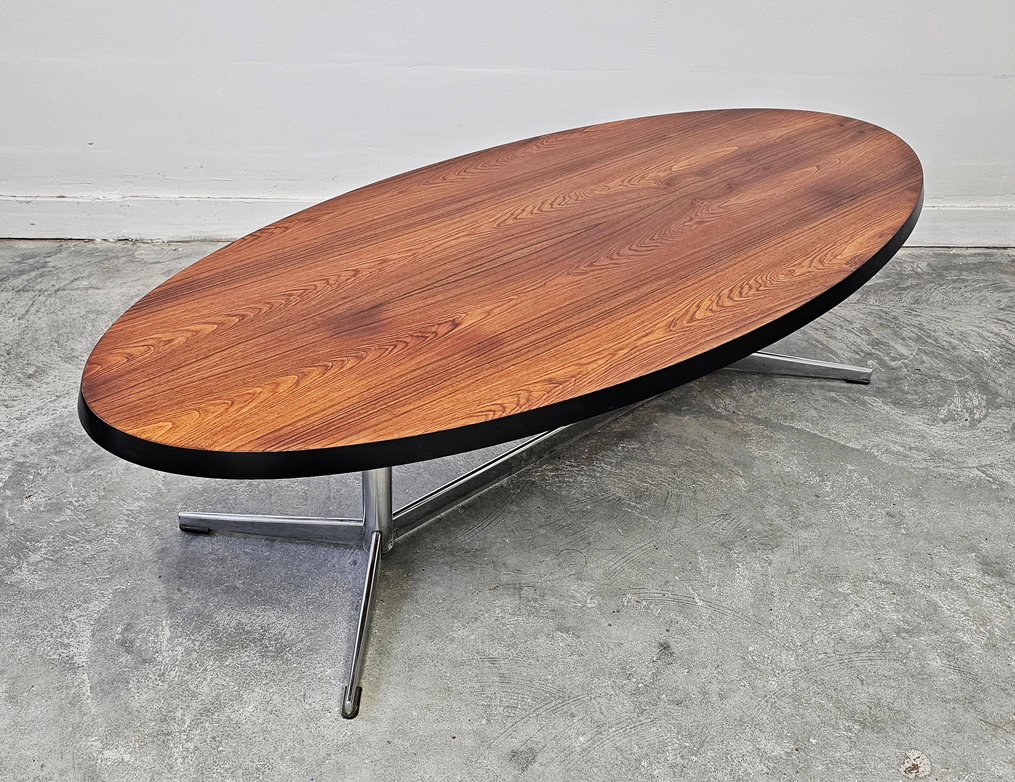Danish Mid Century Modern oval coffee table with a teak top and chrome legs.