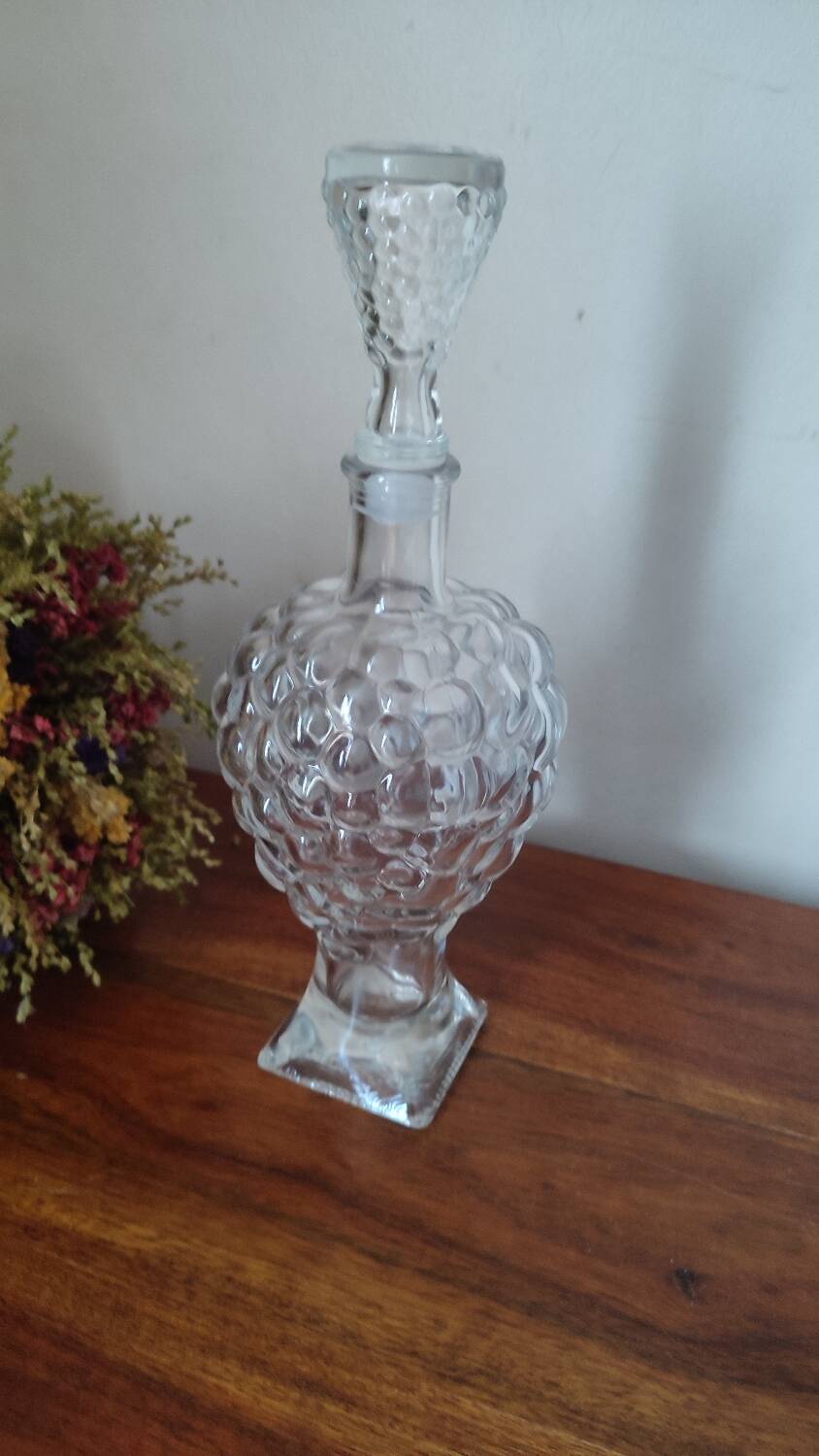Pressed glass carafe in the shape of a bunch of grapes.