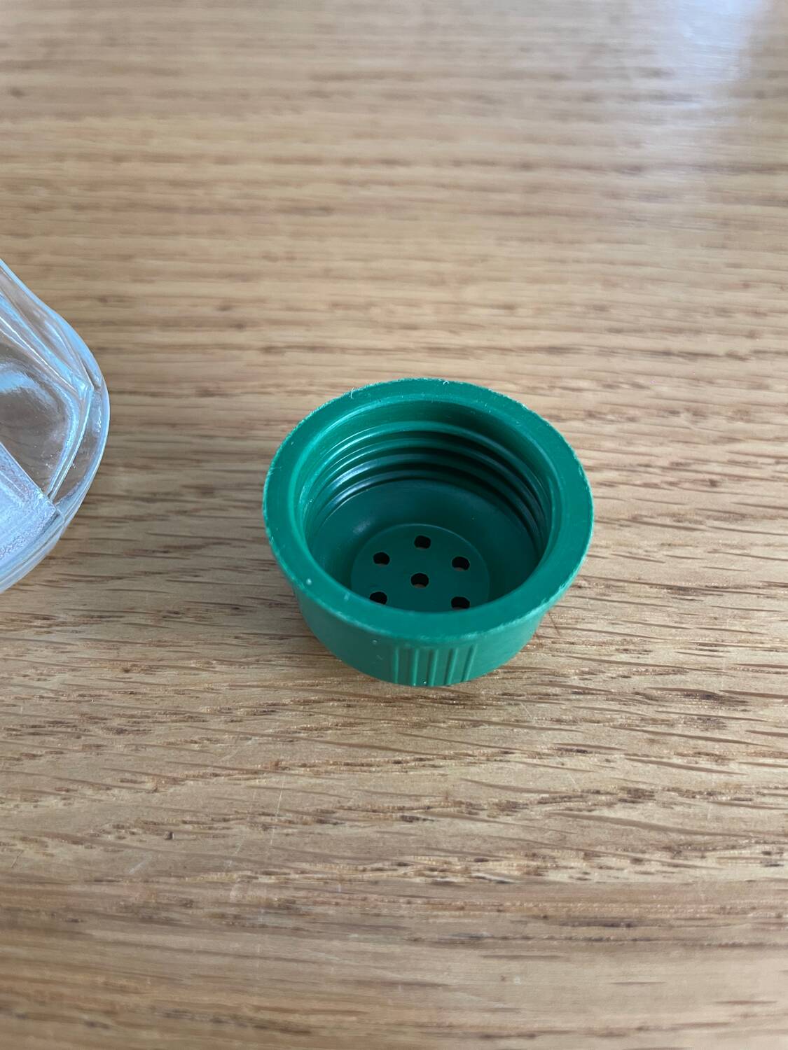 Vintage salt shaker with green Bakelite cap