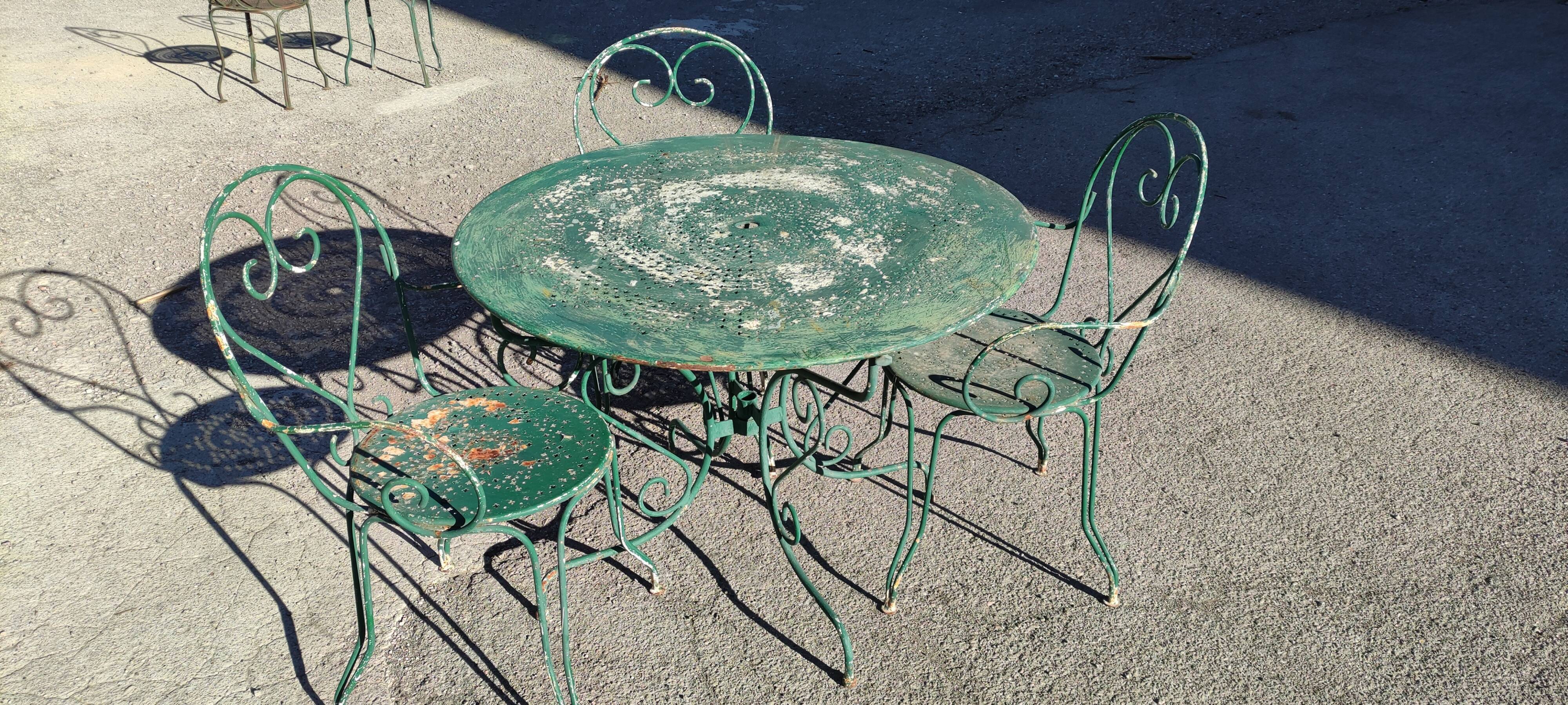 Garden table, two armchairs and a metal chair