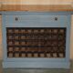 Vintage wooden furniture for 45 wine bottles with a drawer.