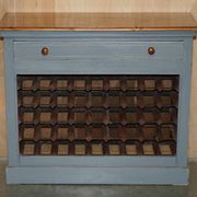 Vintage wooden furniture for 45 wine bottles with a drawer.