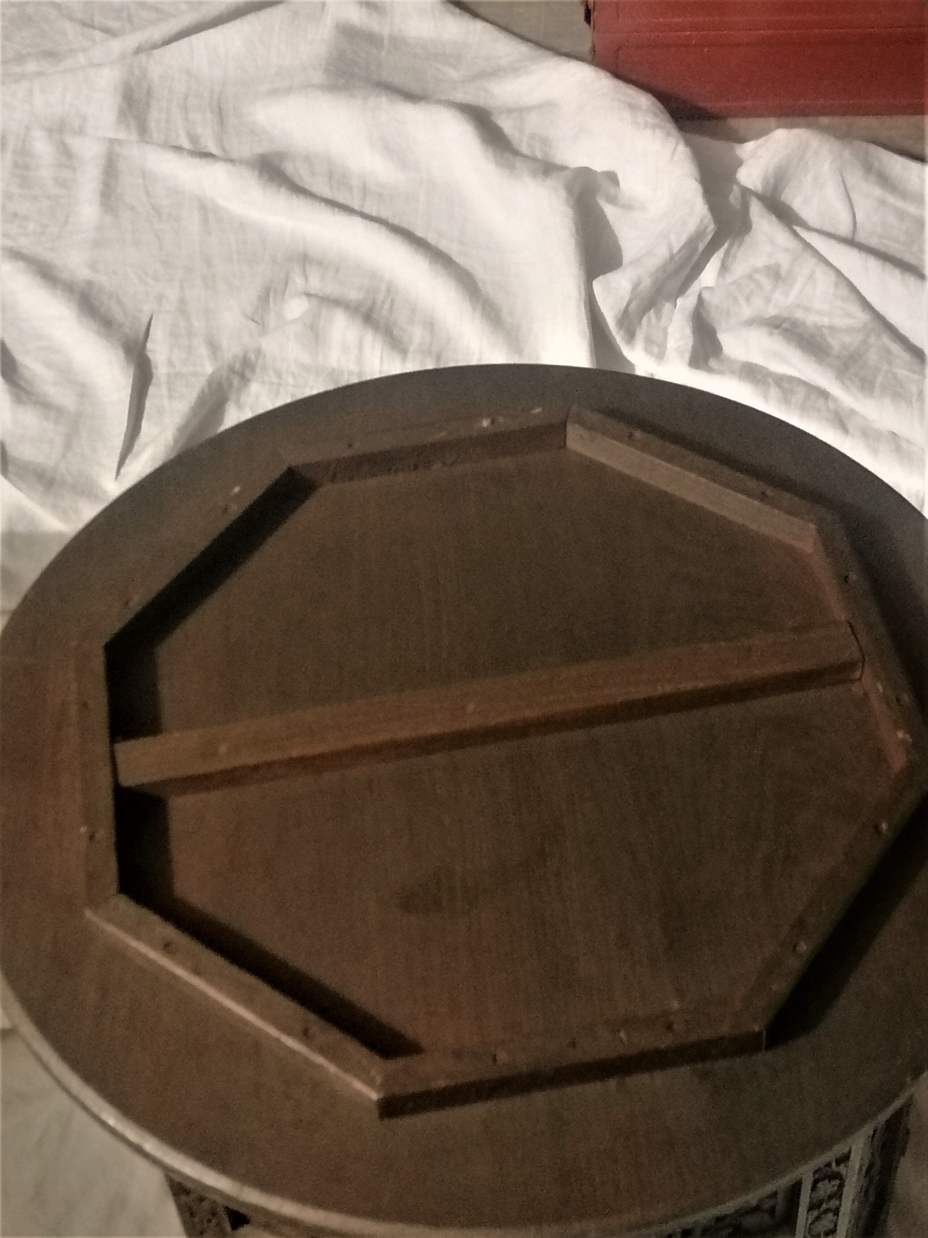 Ancient oriental pedestal table in carved wood