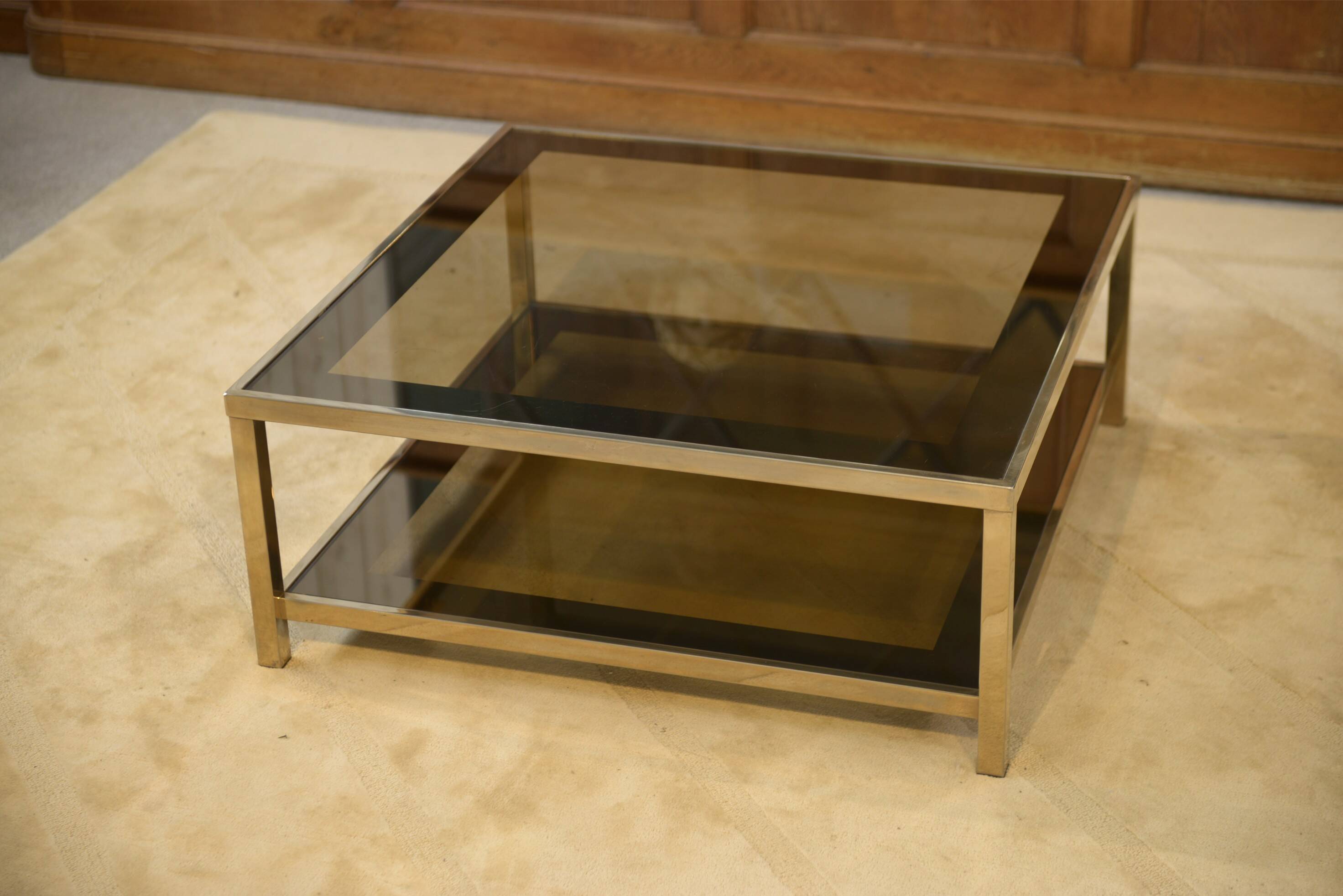 Hollywood Regency coffee table in smoked glass with mirrored framing from the 1970s.