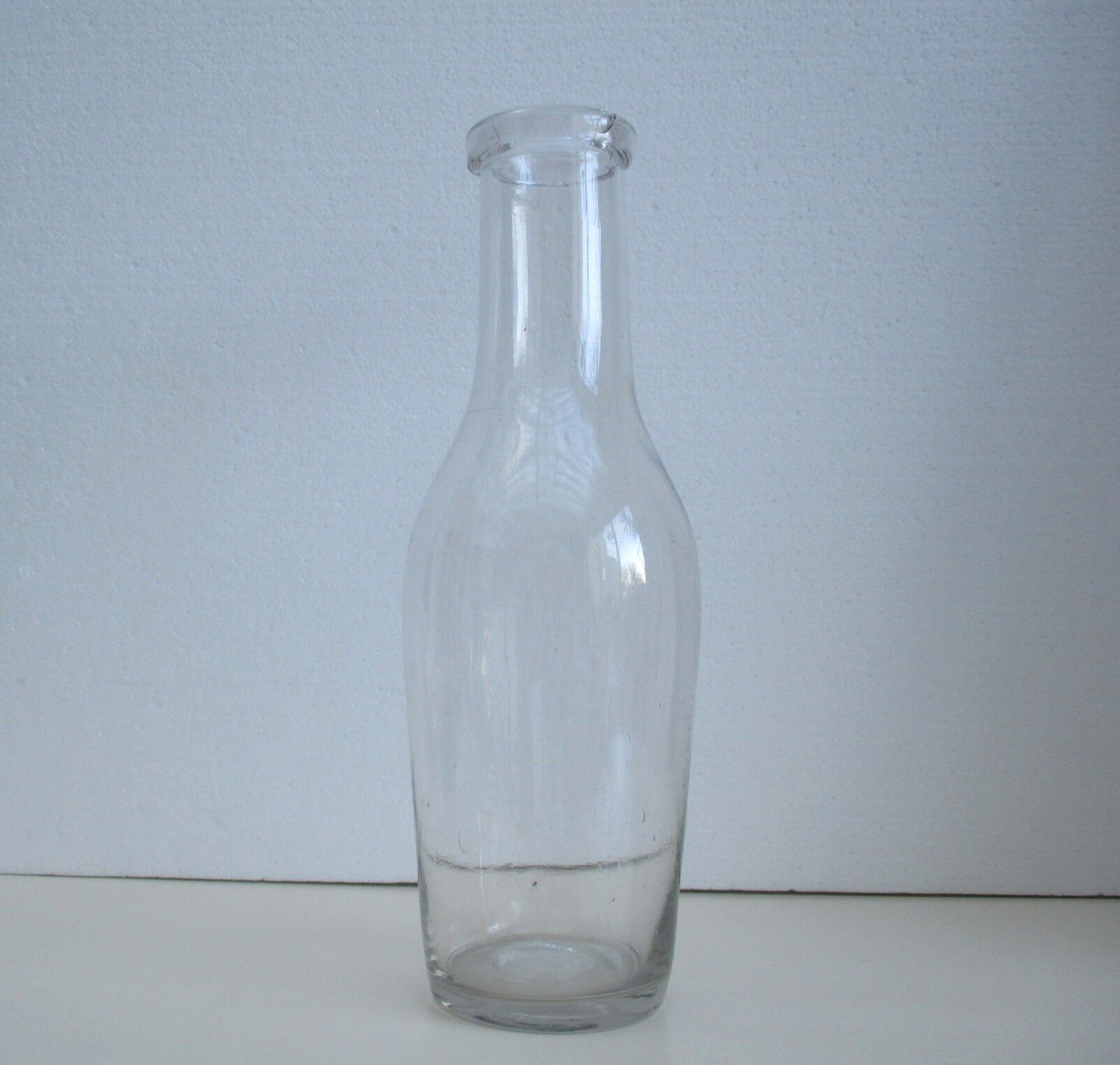 Large antique bottle made of blown glass