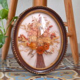 Medallion of dried flowers with a domed frame