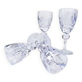 Cut crystal white wine glasses with a slender baluster-shaped stem.
