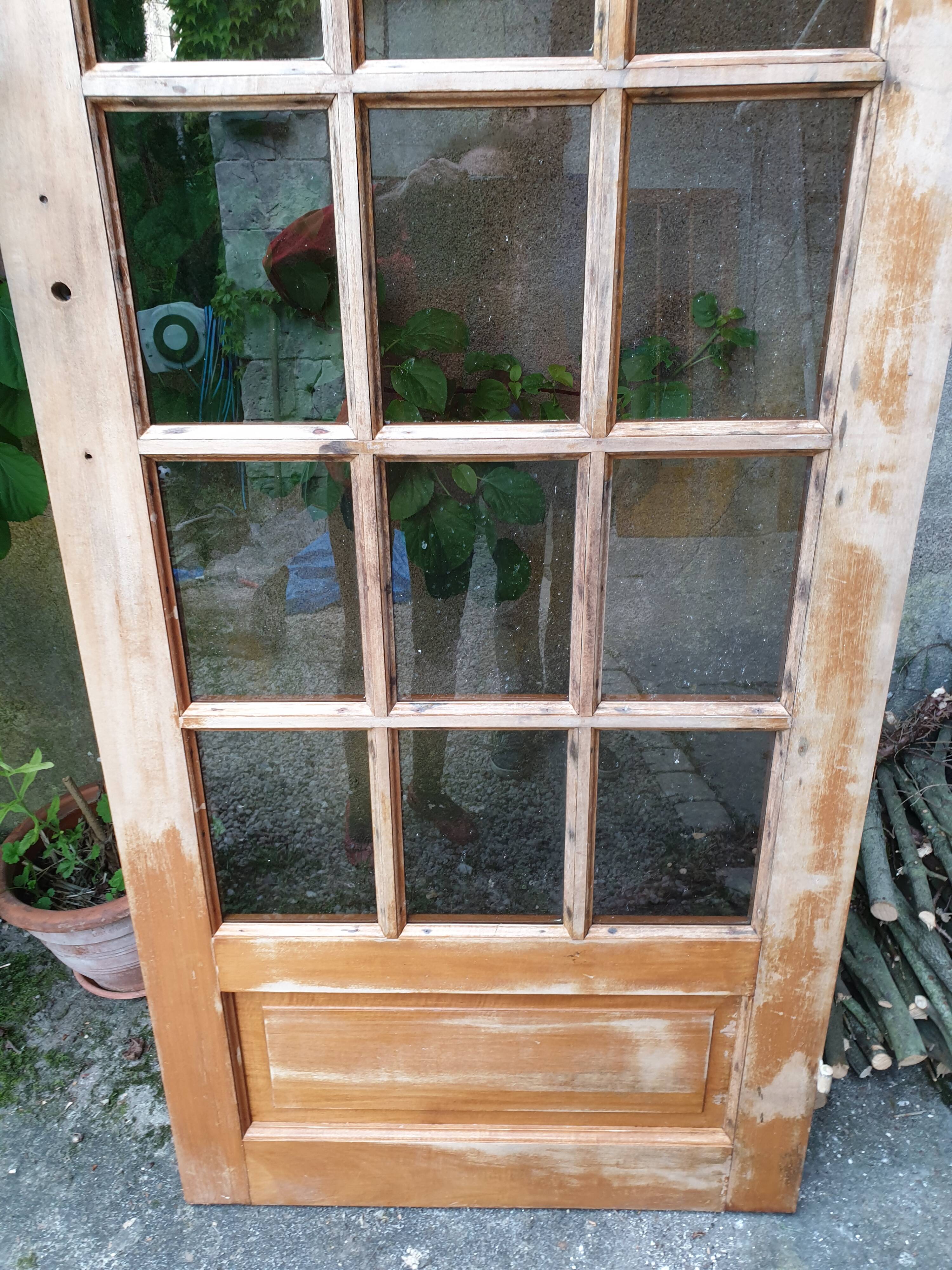 Old wooden door glazed with small tiles