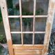 Old wooden door glazed with small tiles