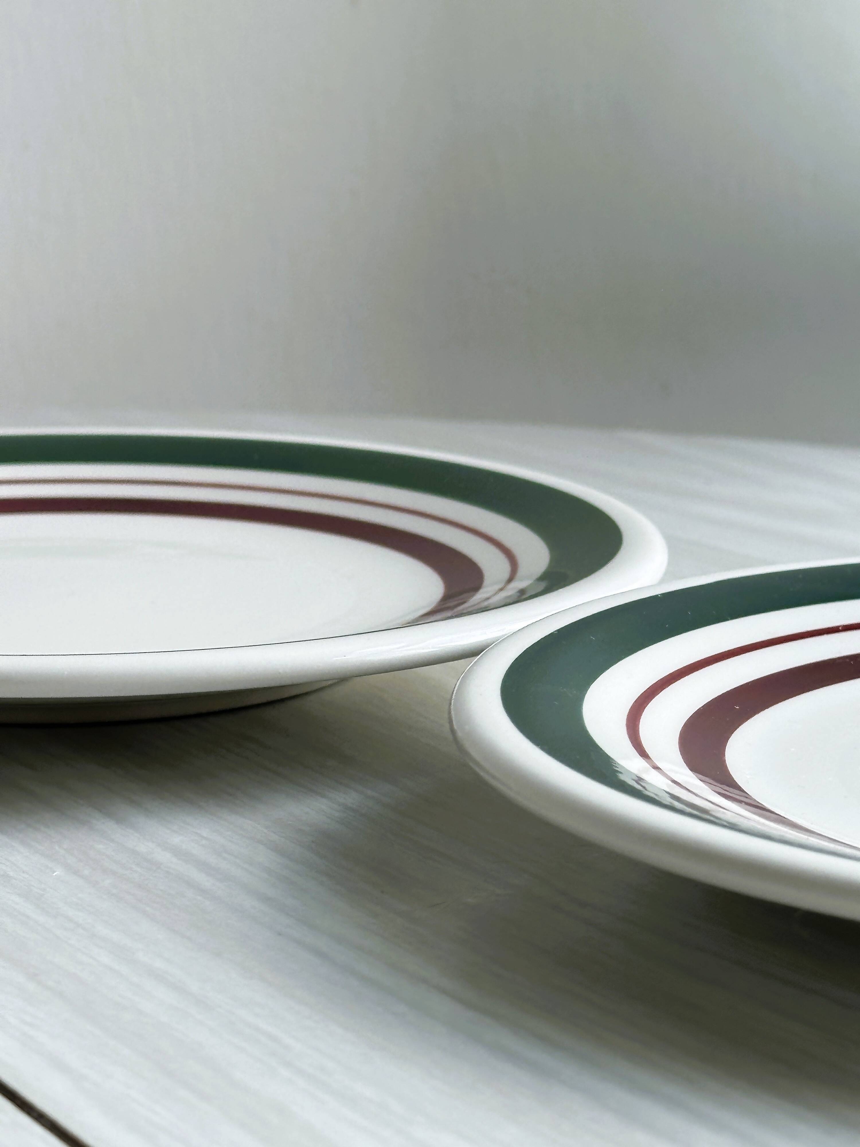 2 green and burgundy strip dessert plates.