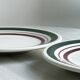 2 green and burgundy strip dessert plates.
