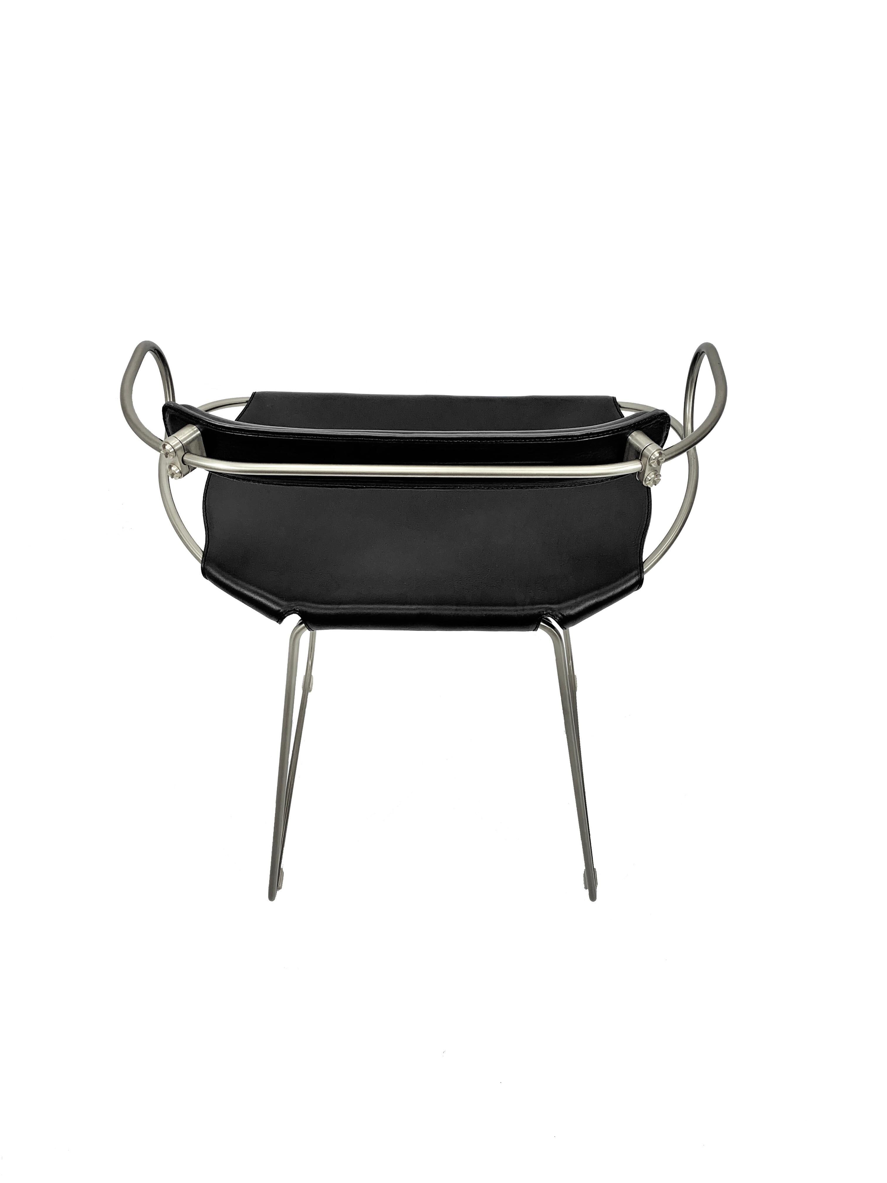 Kitchen stool with a weathered silver steel backrest and black seat.