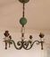 Art Deco chandelier in wrought iron, brass, and glass.