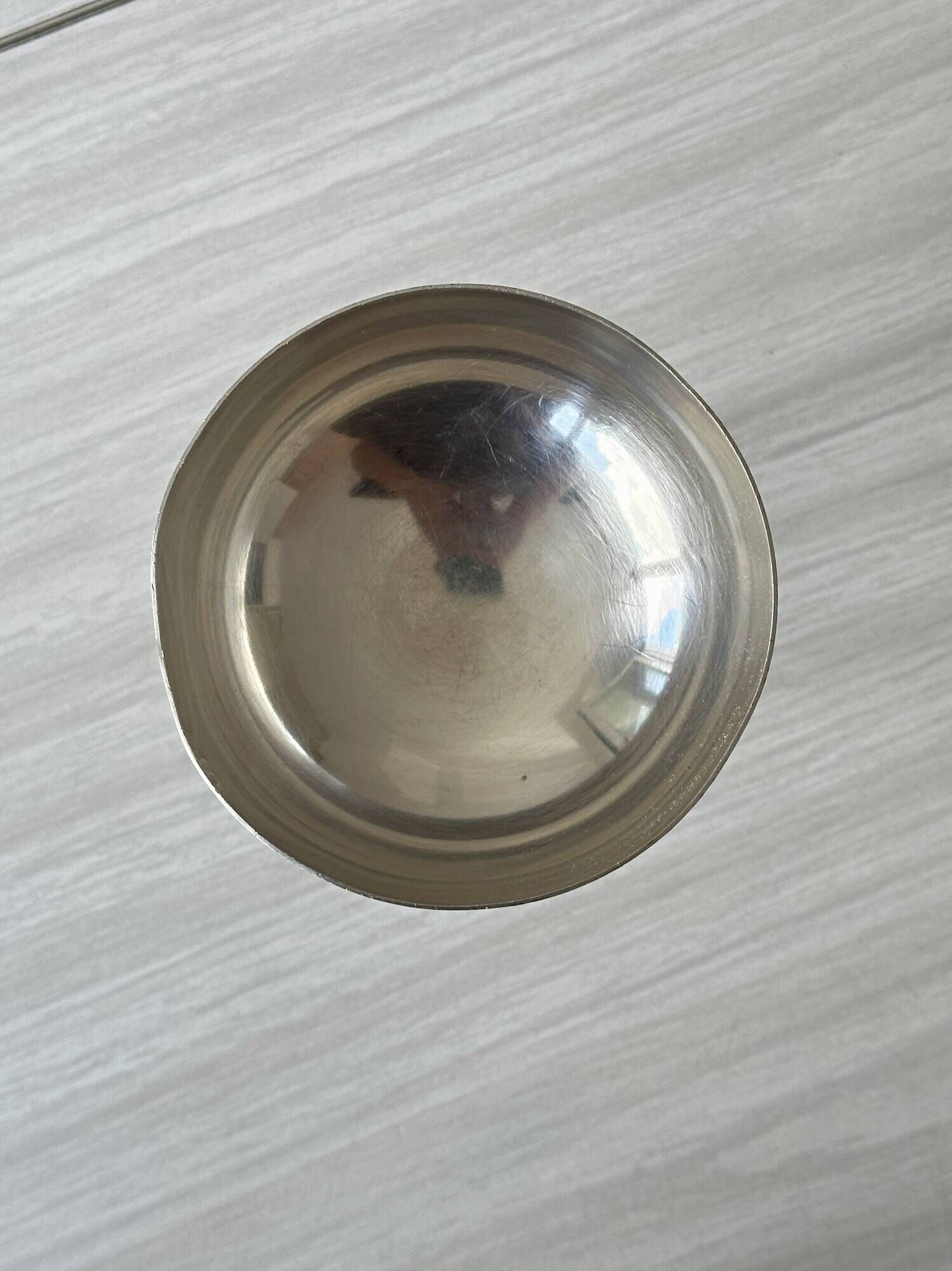 Silver-plated metal stand.