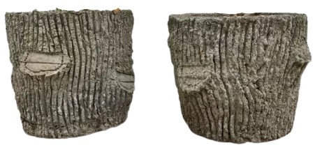 Two cement planters imitation tree trunks