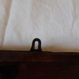 old wall coat holder made up of 3 wooden and metal pads.