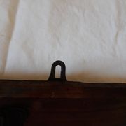 old wall coat holder made up of 3 wooden and metal pads.