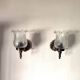 Pair of wall sconces in bronze with opaline glass tulips.
