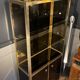 Hollywood Regency style bookcase shelf, gilded brass and black lacquered wood, 1970