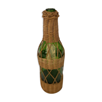 Green bottle with wicker decoration