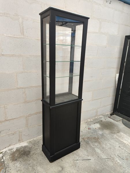 Old wooden window of black patina store two doors