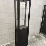 Old wooden window of black patina store two doors